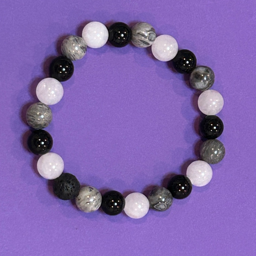 handmade beaded bracelet with grey map jasper, onyx, white jade, and lava rock.